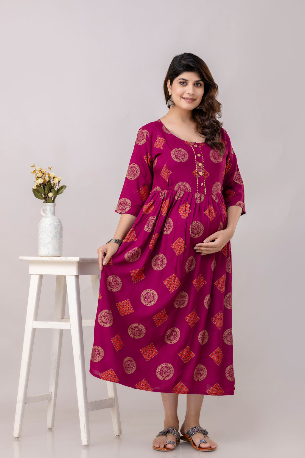 HENAL G-H417 wine printed maternity dress, full front view with one side of the skirt held out to show the flare.