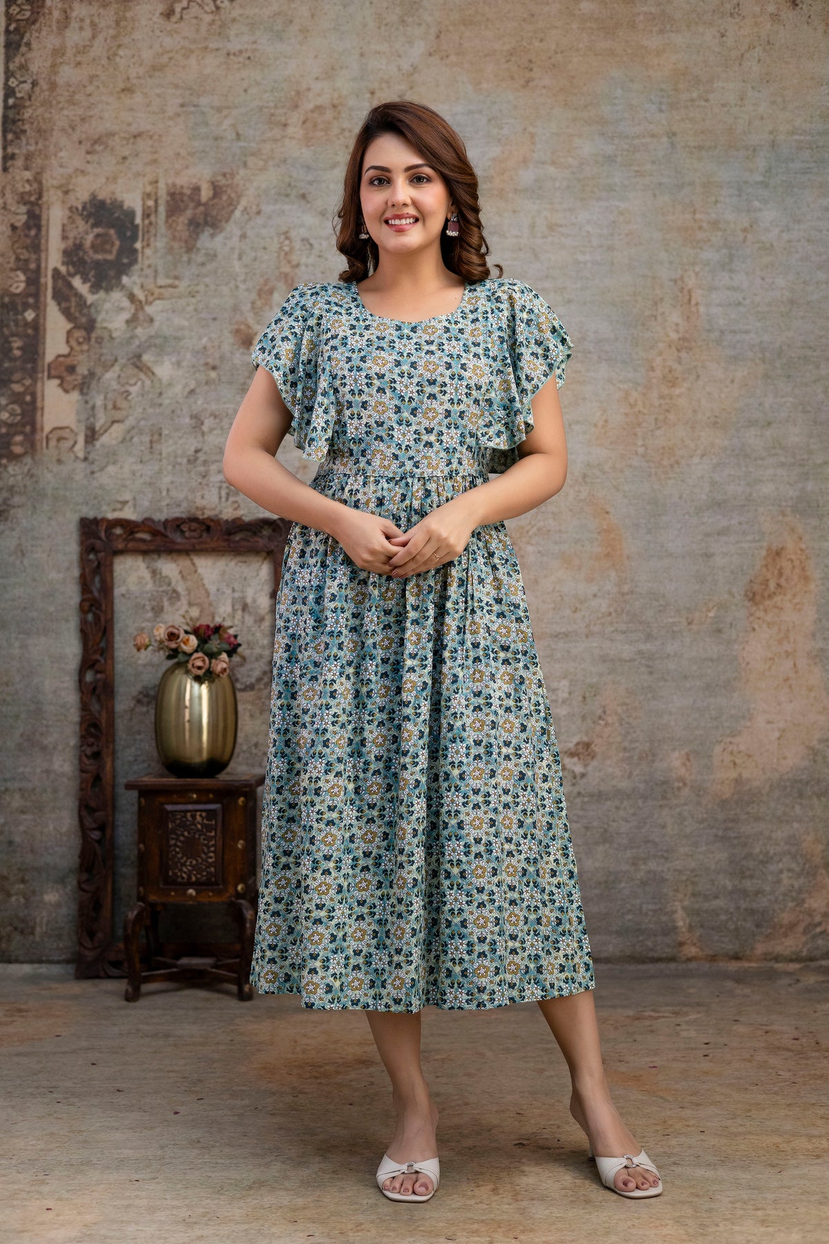 Grey printed nursing dress shown from the front with hands clasped