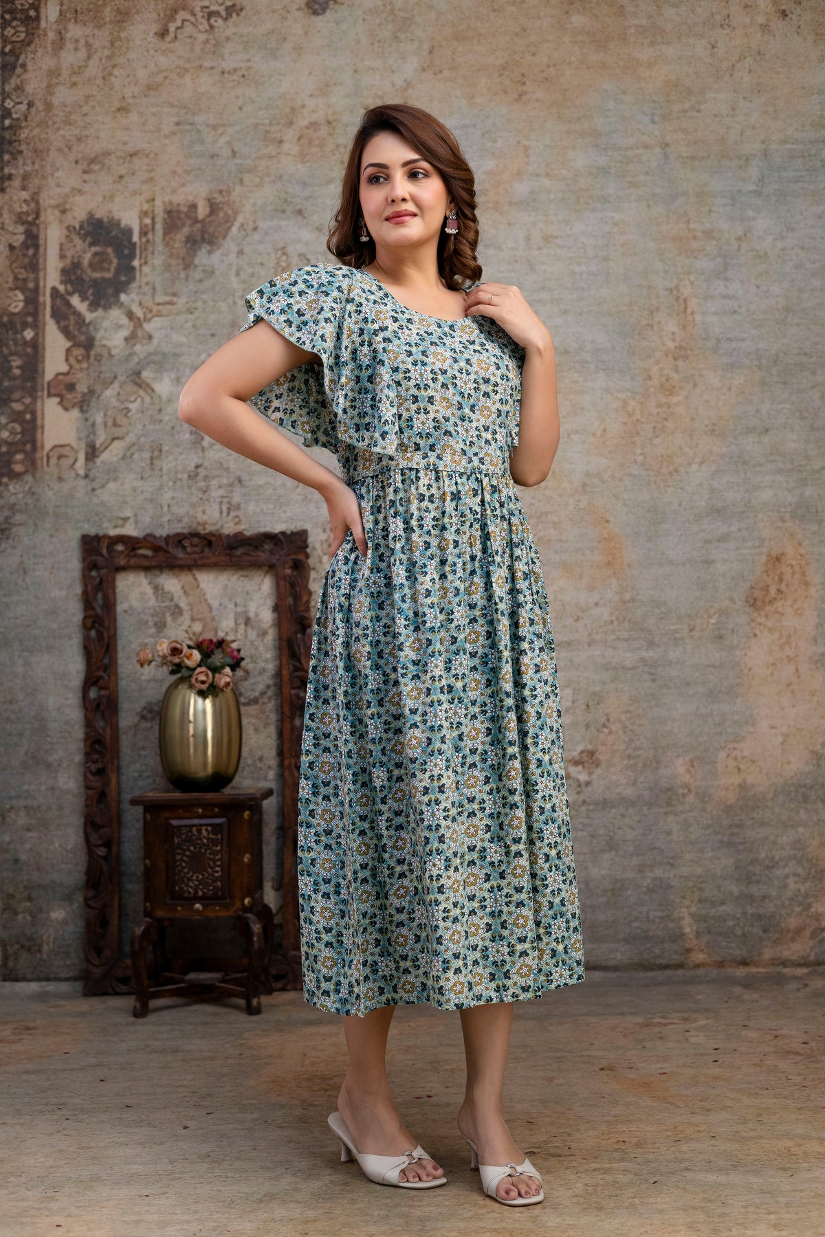 Angled view of grey printed nursing dress with a flared skirt