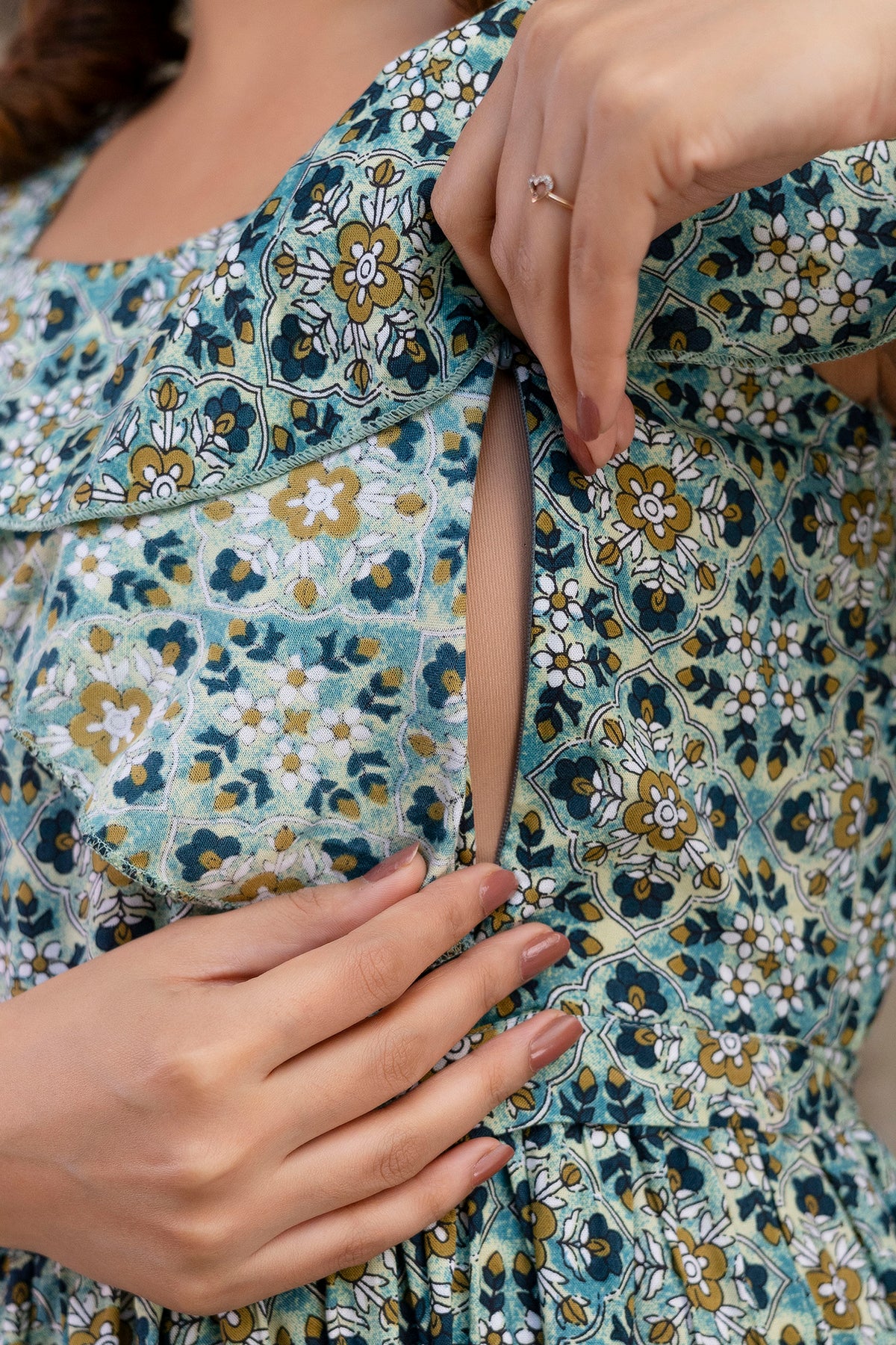 Close-up showing the open concealed nursing zip on grey printed dress