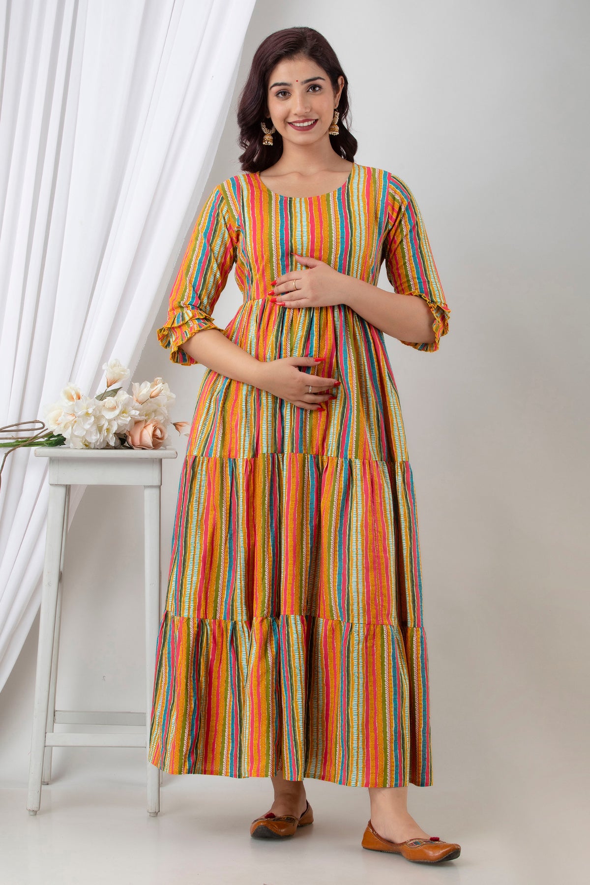 HENAL G-H362 multicolour striped maternity dress: front view with both hands on bump.