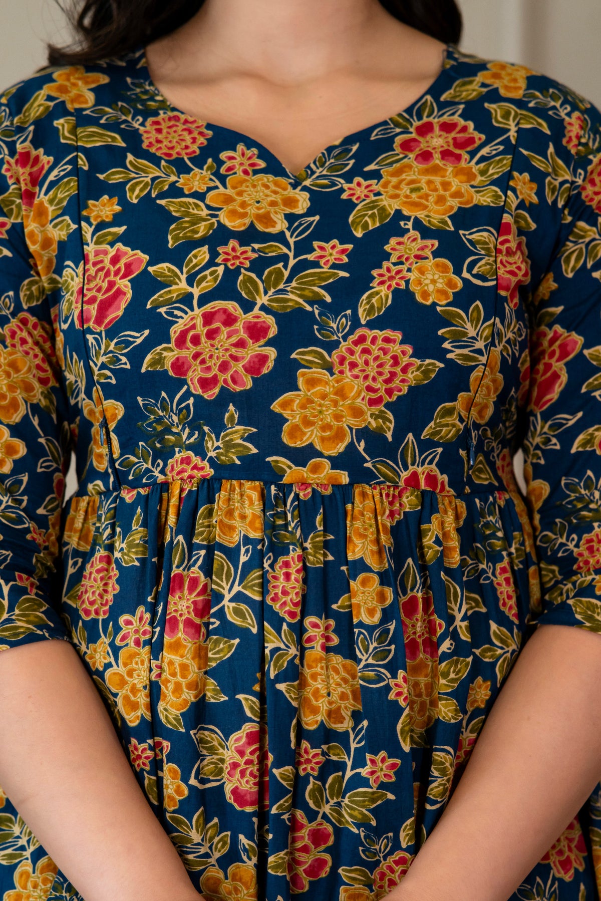 Close-up of blue floral kurta showing the neckline and gathered waist
