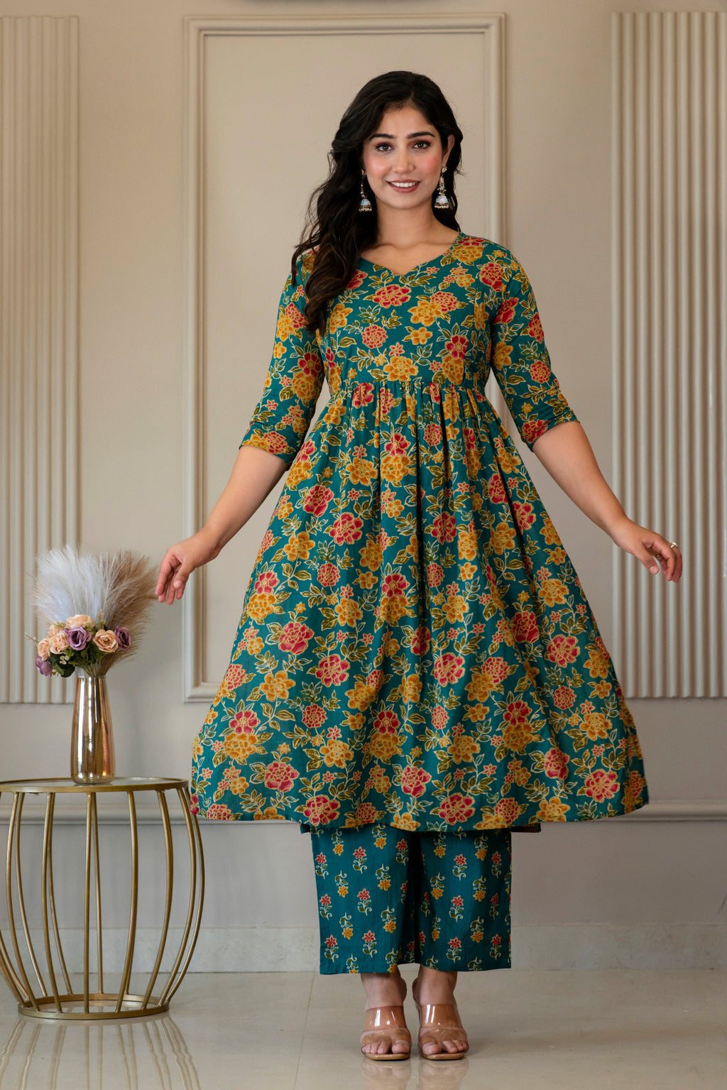 Front view of green floral kurta held out to show its flared shape