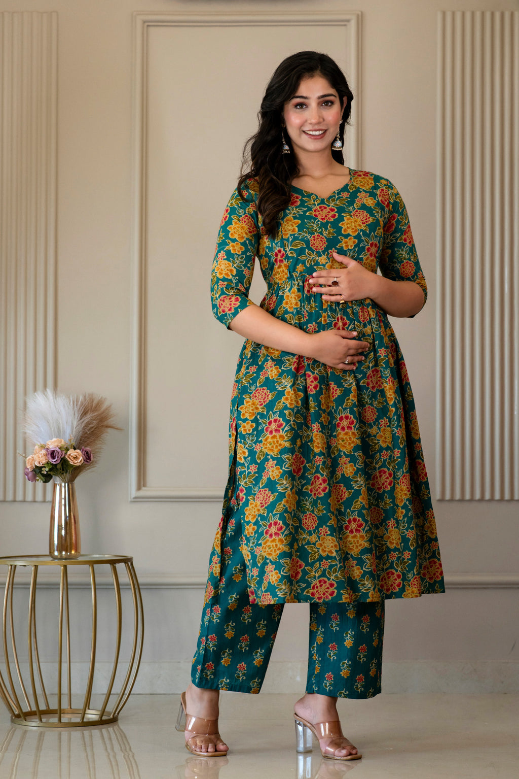 Angled front view of green floral kurta and matching palazzo trousers