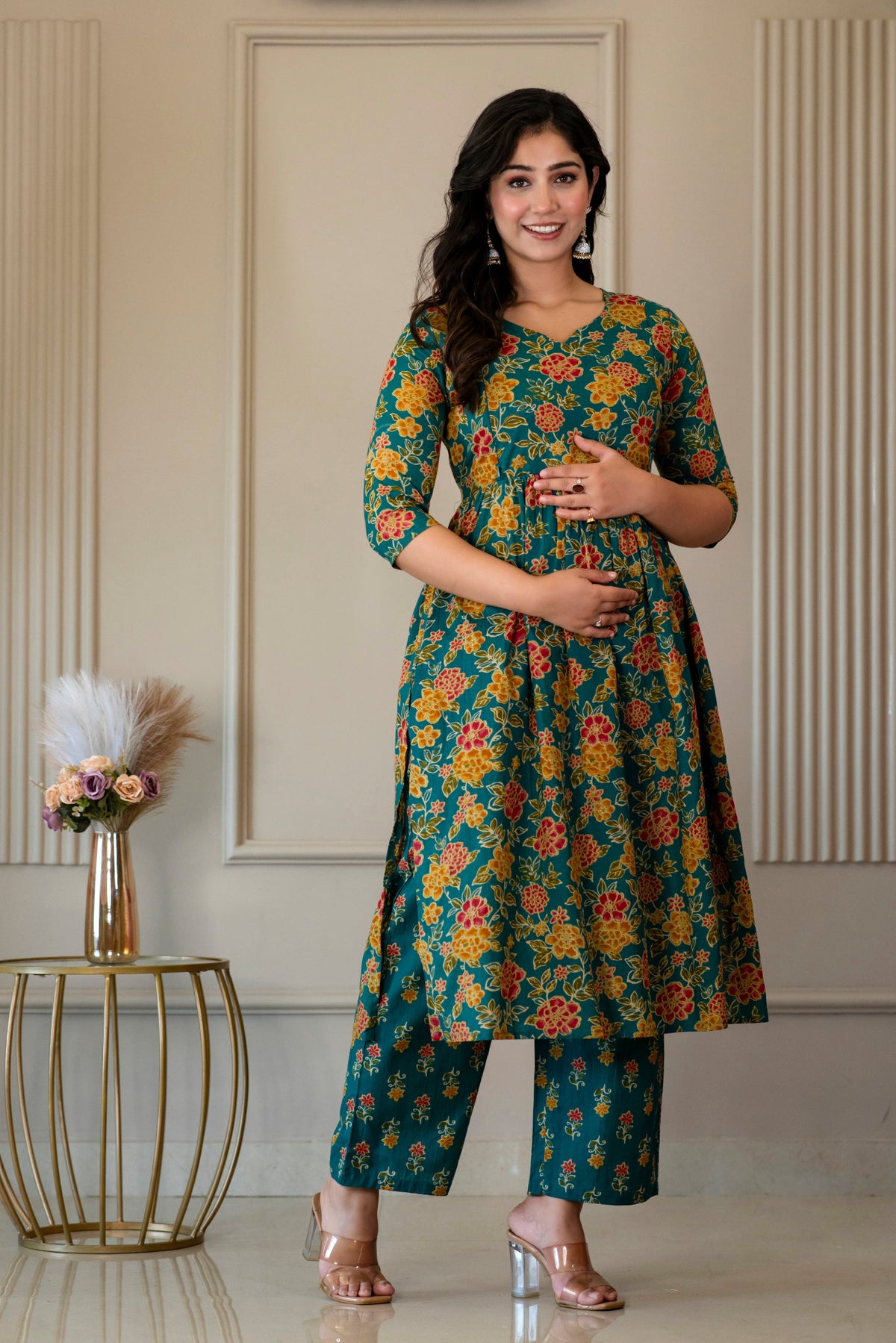 Angled front view of green floral kurta and matching palazzo trousers