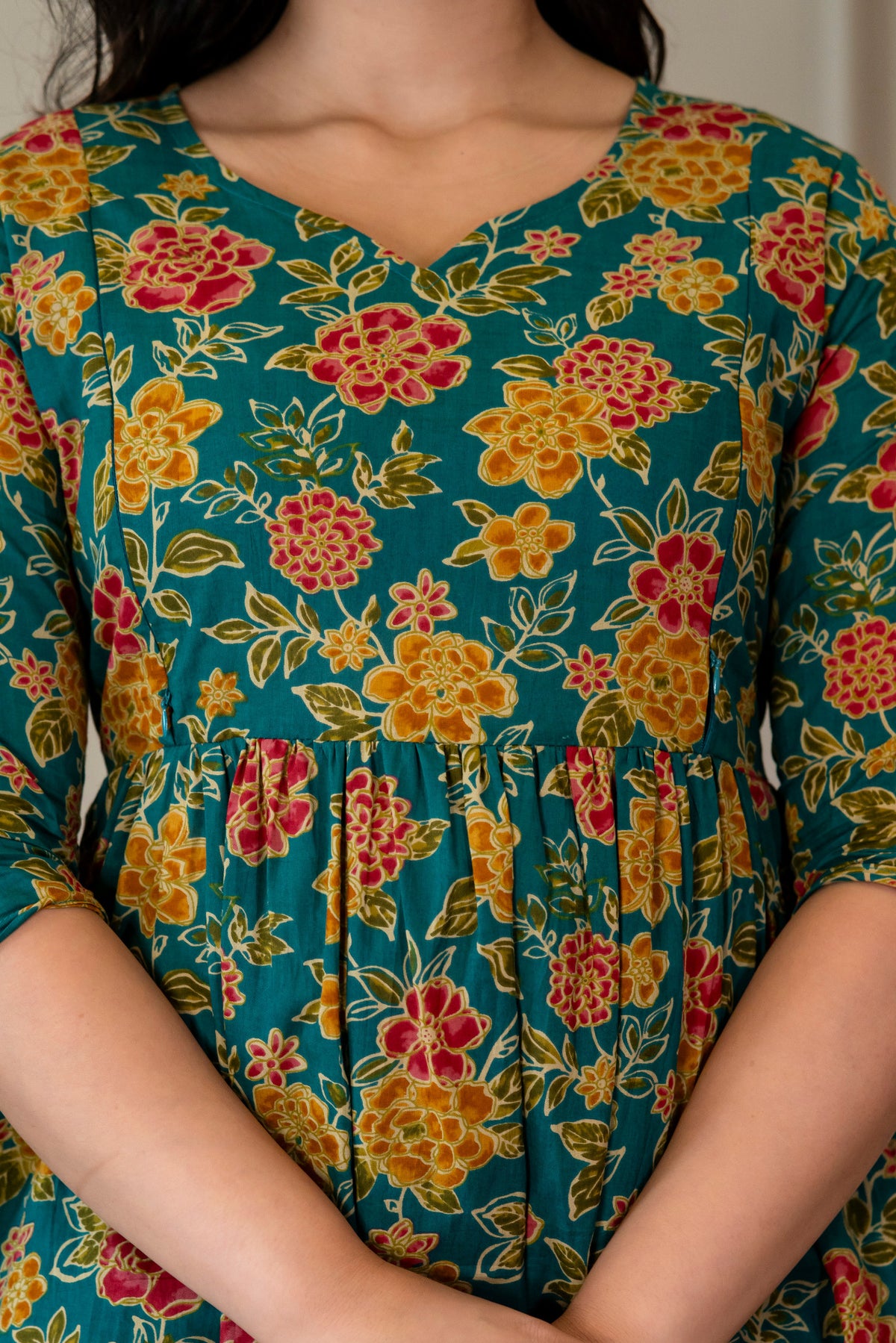 Close-up of green floral kurta showing the neckline and gathered waist