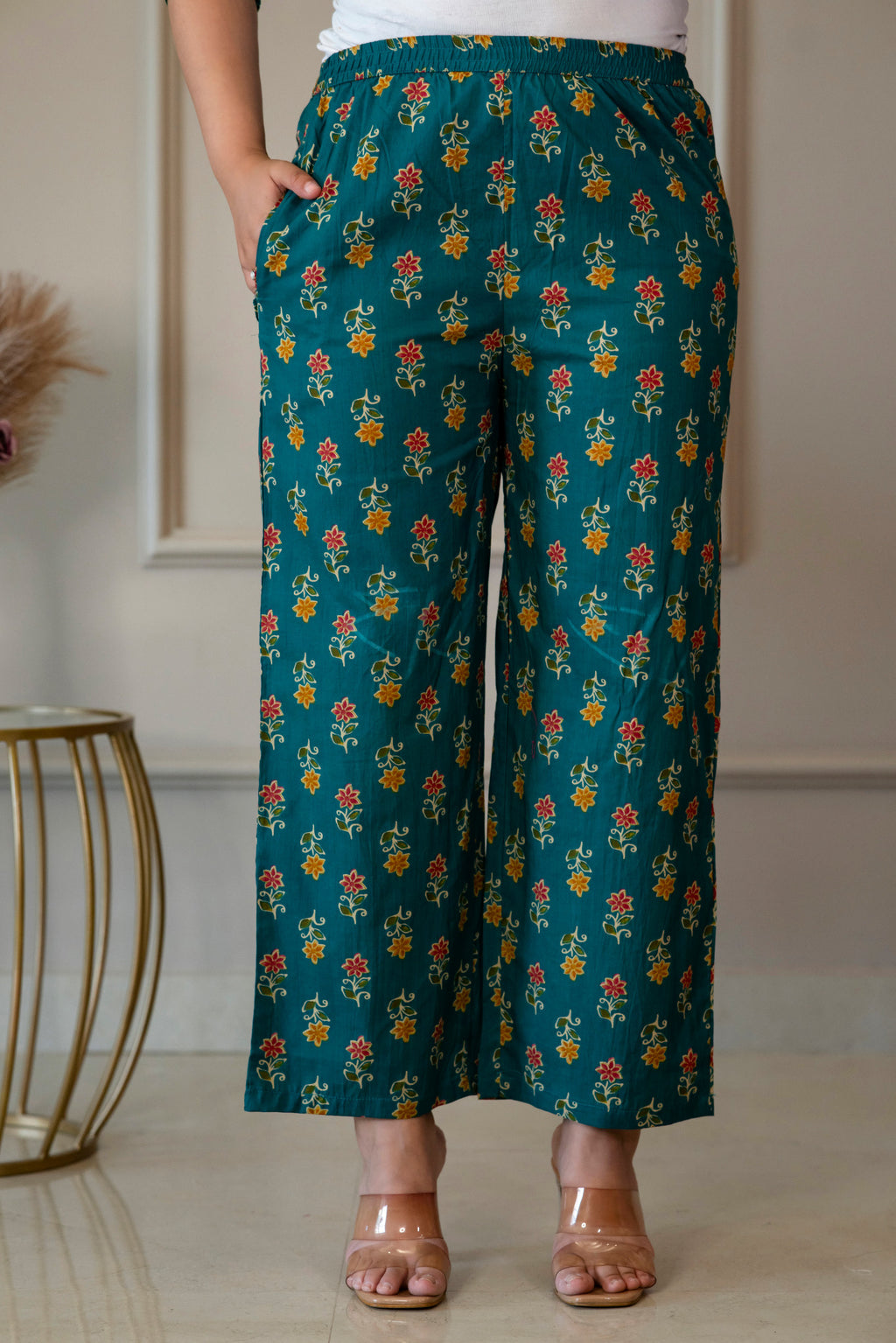 Front view of green floral palazzo trousers showing the waistband and side pocket