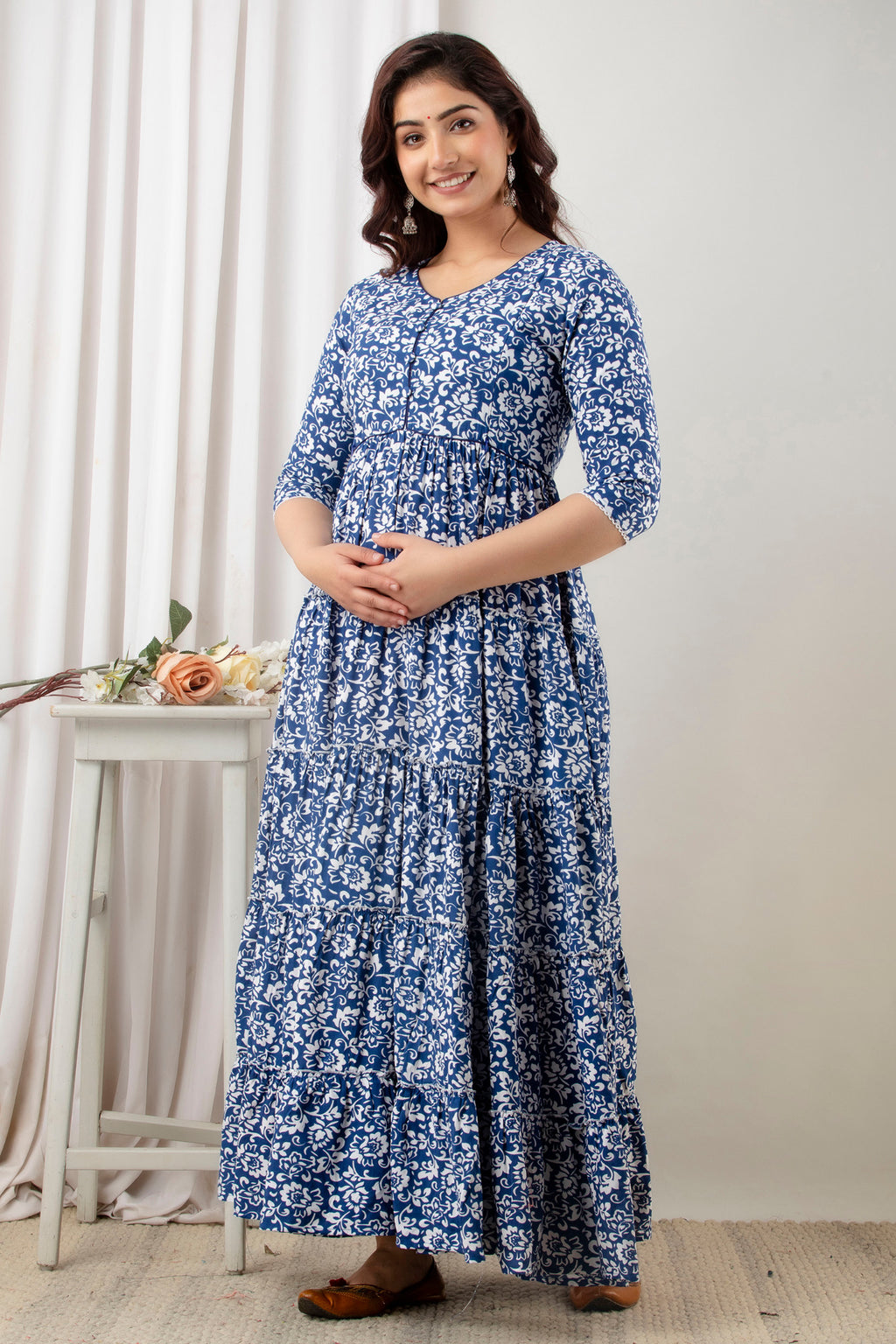 HENAL G-H378 blue and white floral maternity gown, three-quarter front view with hands clasped.