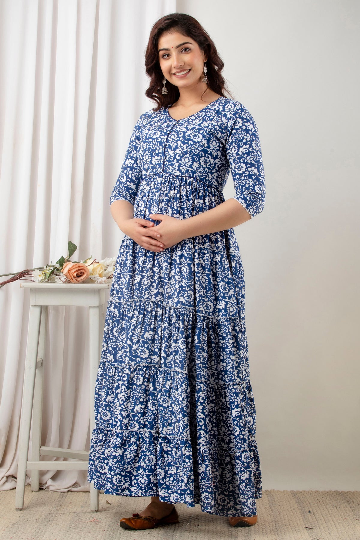 HENAL G-H378 blue and white floral maternity gown, three-quarter front view with hands clasped.