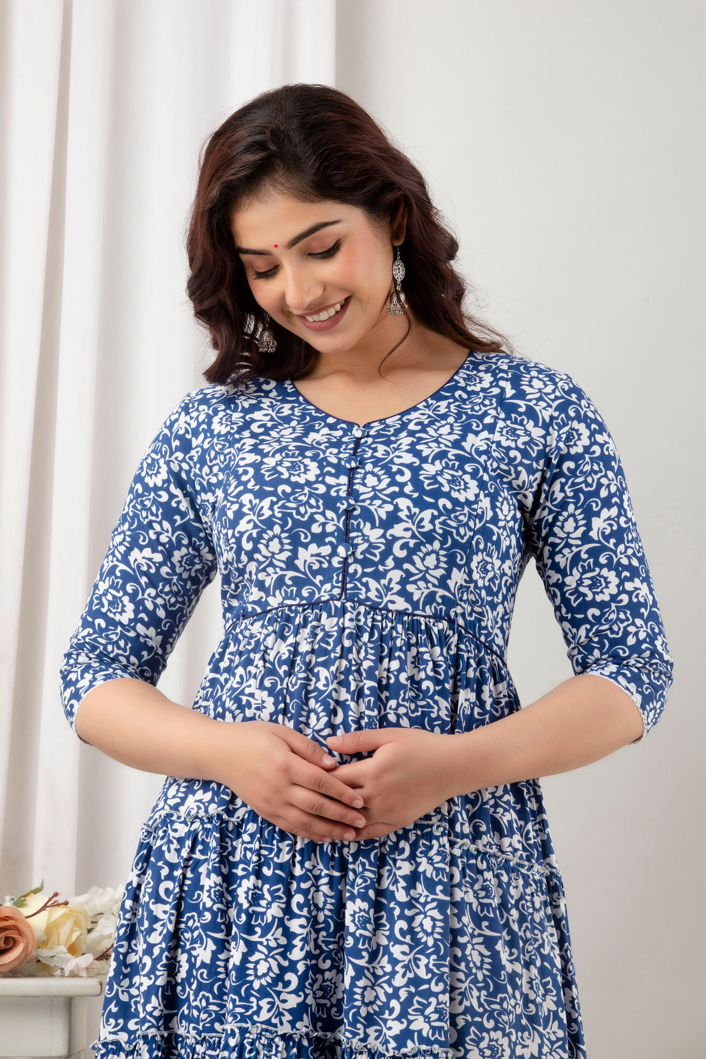 HENAL G-H378 blue and white floral maternity gown, upper-body front view with hands clasped.