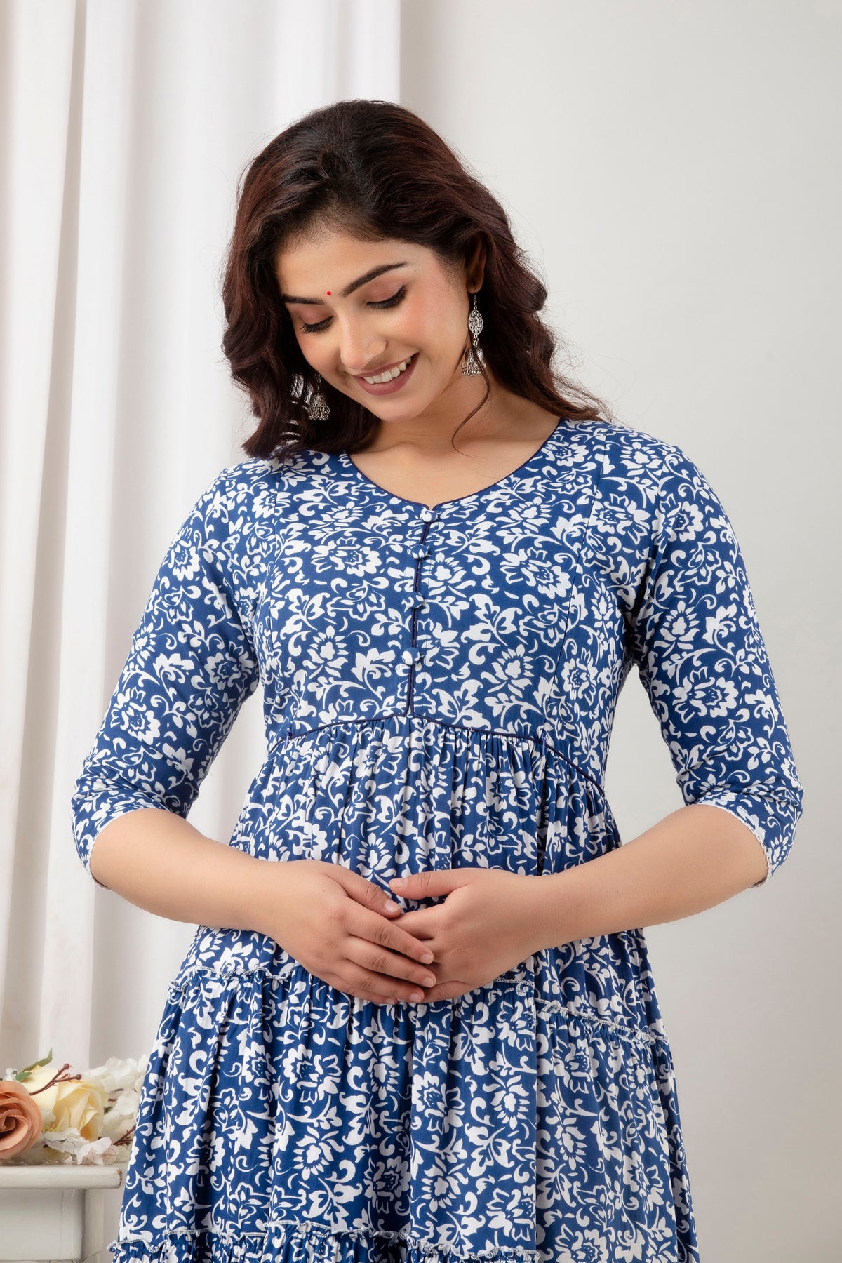 HENAL G-H378 blue and white floral maternity gown, upper-body front view with hands clasped.
