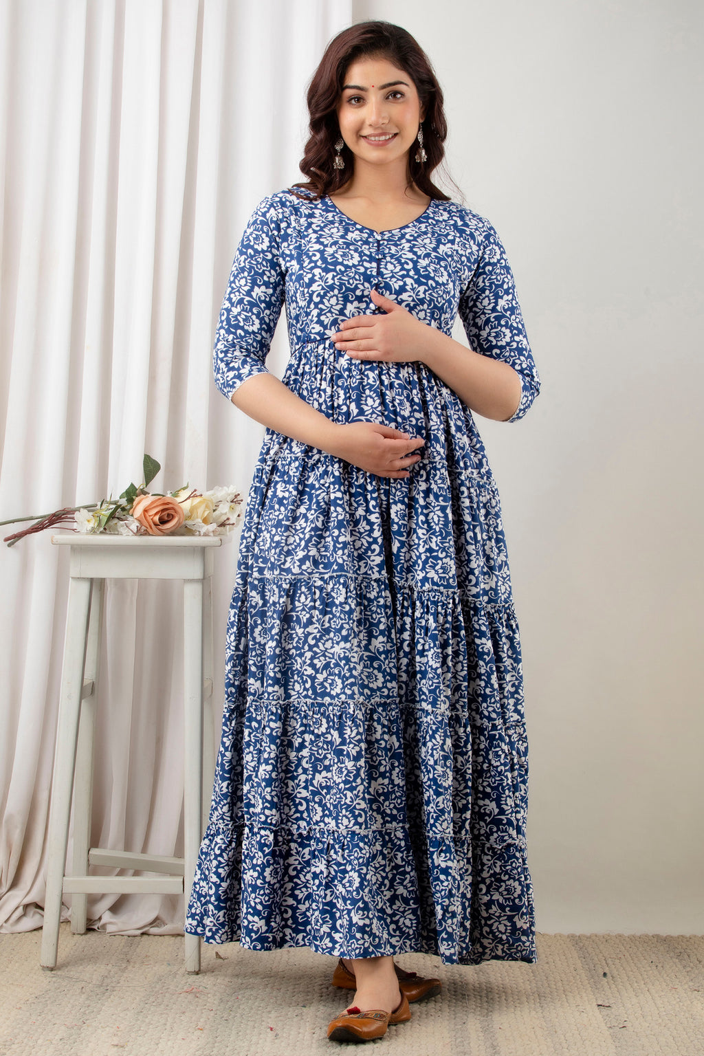 HENAL G-H378 blue and white floral maternity gown, full-length front view with hands at the bodice and waist.