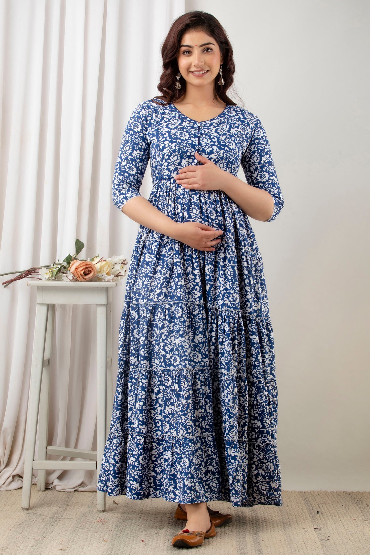 HENAL G-H378 blue and white floral maternity gown, full-length front view with hands at the bodice and waist.