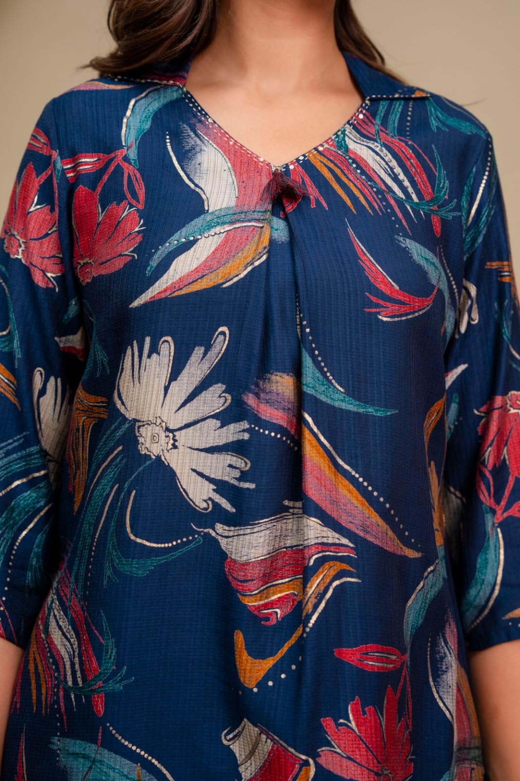 Close-up of the neckline and multicolour floral print on the navy top