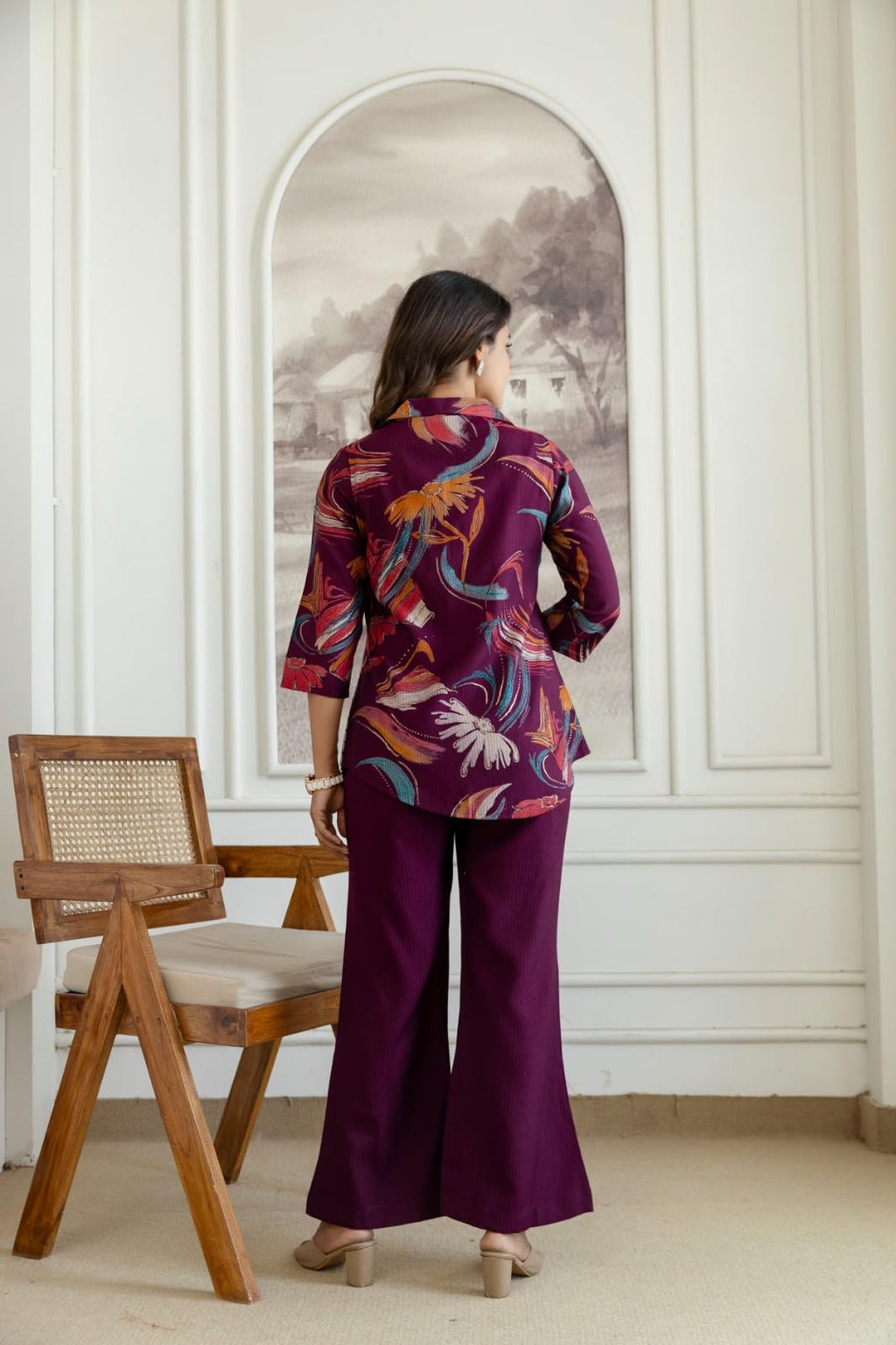Back view of wine floral top and wide-leg trousers