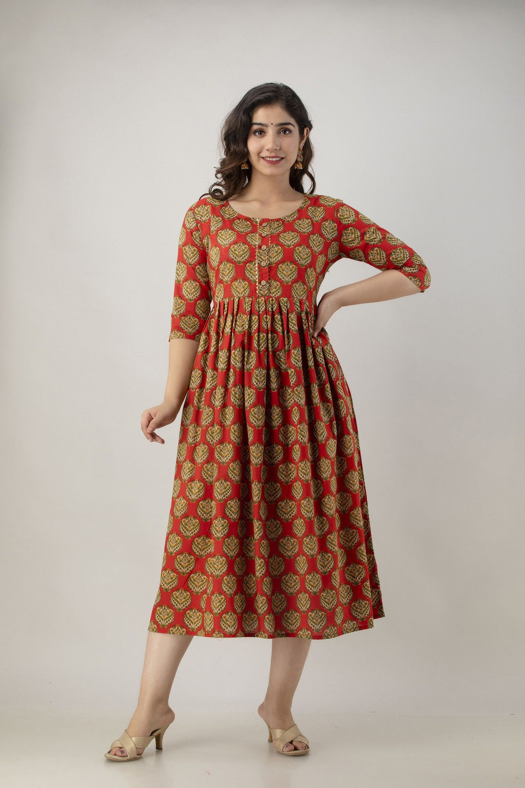 HENAL H345 garment showing orange butti print, gathered waist, flared silhouette.