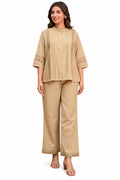 Front view of beige pintuck and cutwork top with matching trousers