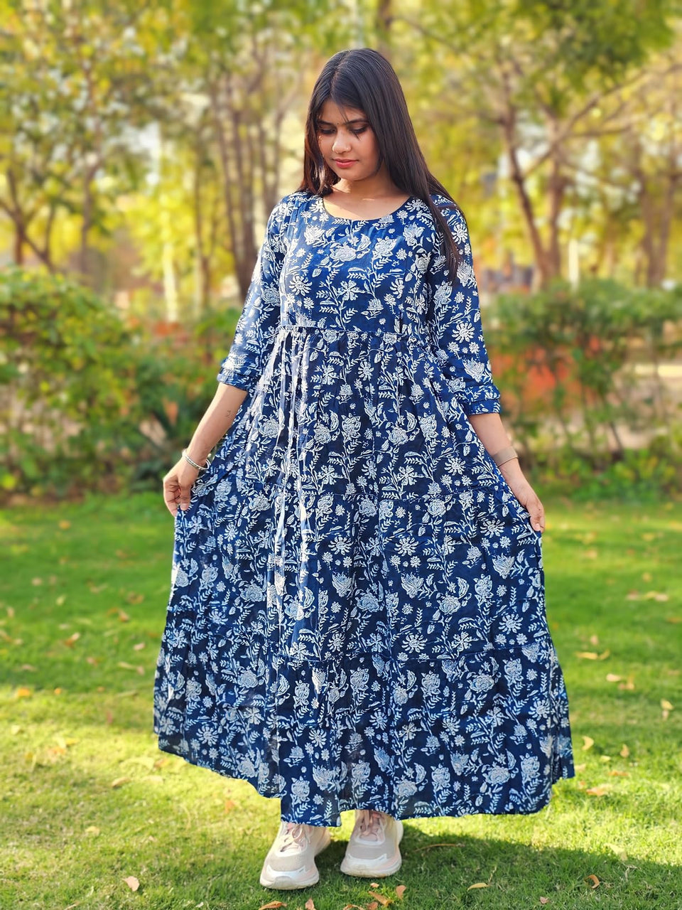 Customer wearing a blue and white floral dress outdoors